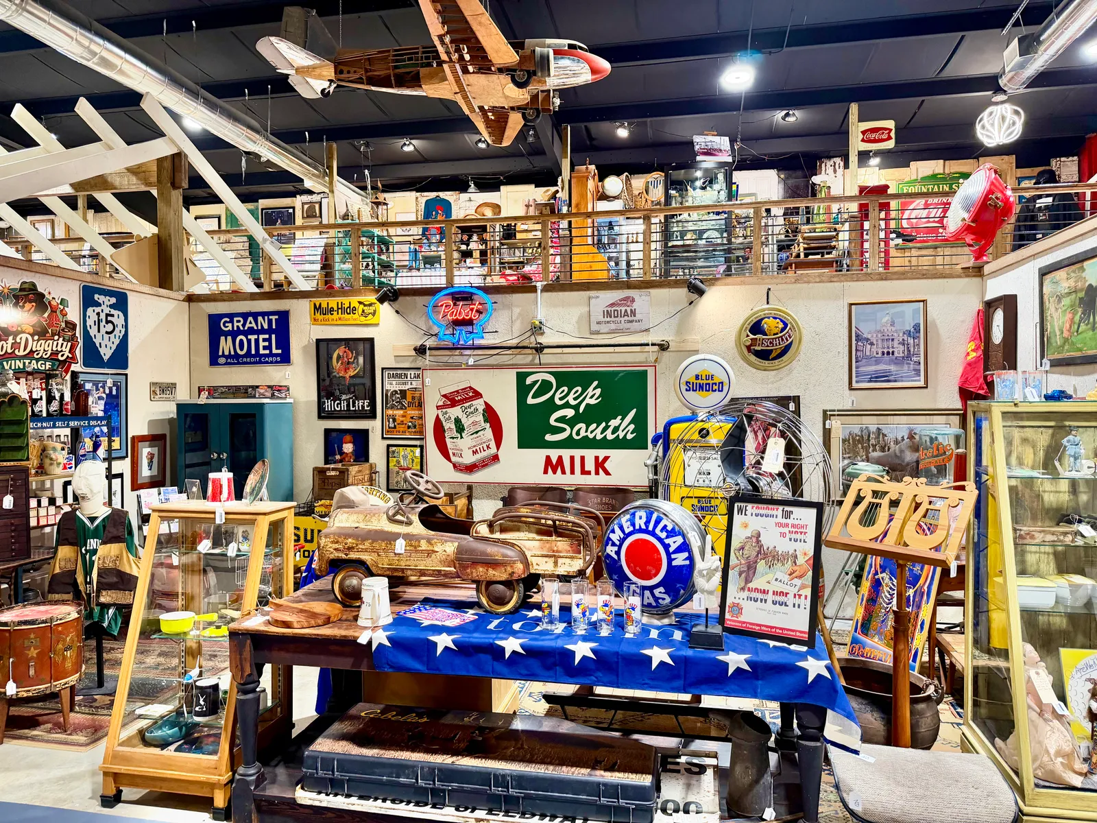 Vintage Deep South Milk signs and a pedal car