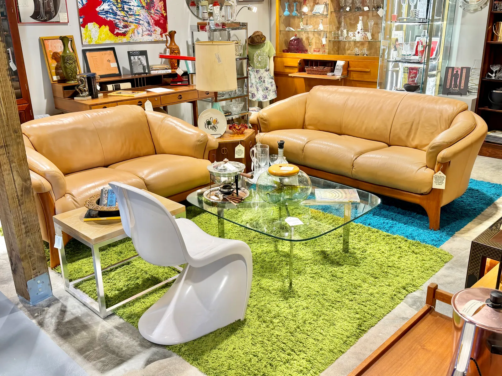 Mid-century tan leather sofas on a green shag rug
