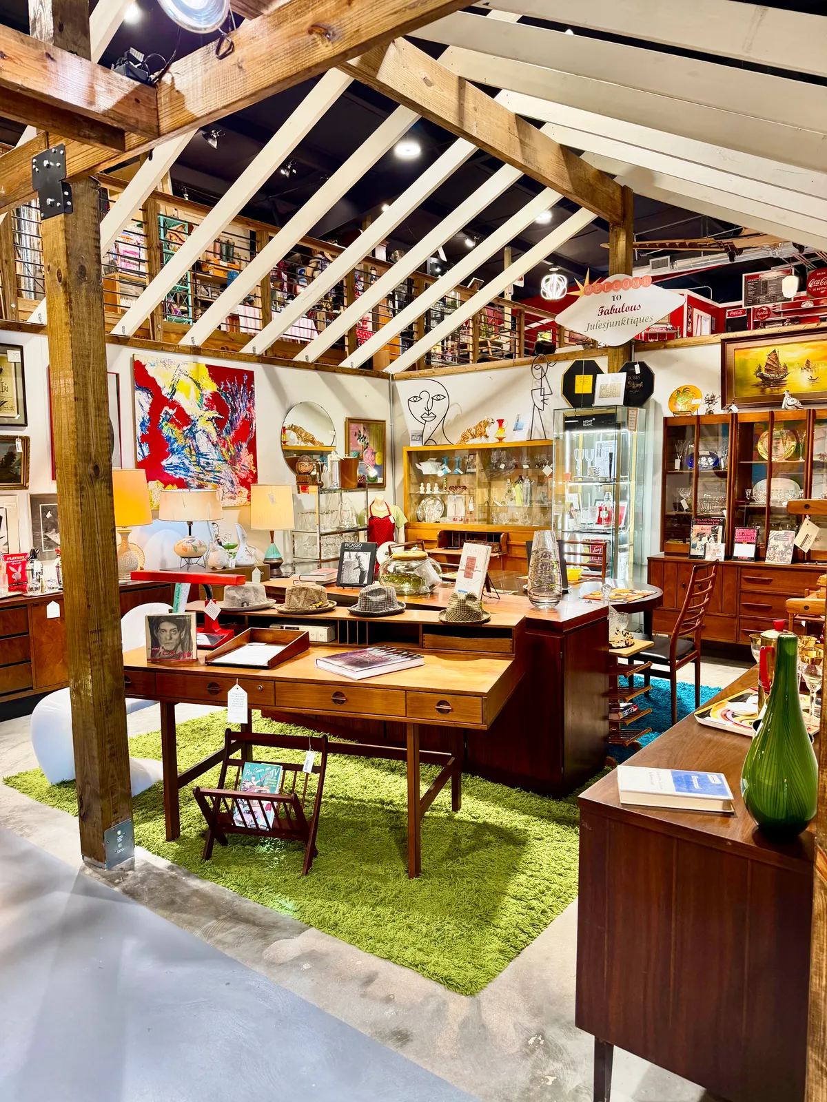 A mid-century furniture booth under the wooden beams
