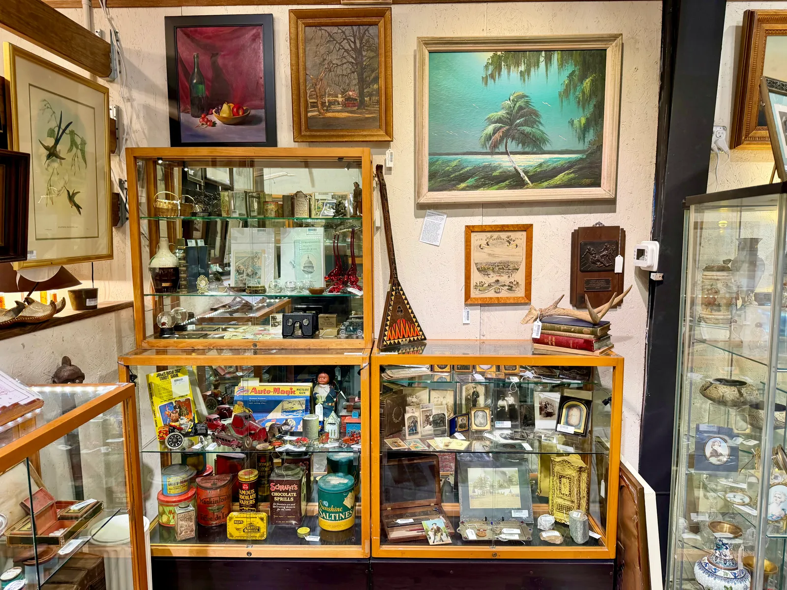 Display cases of collectibles below framed paintings