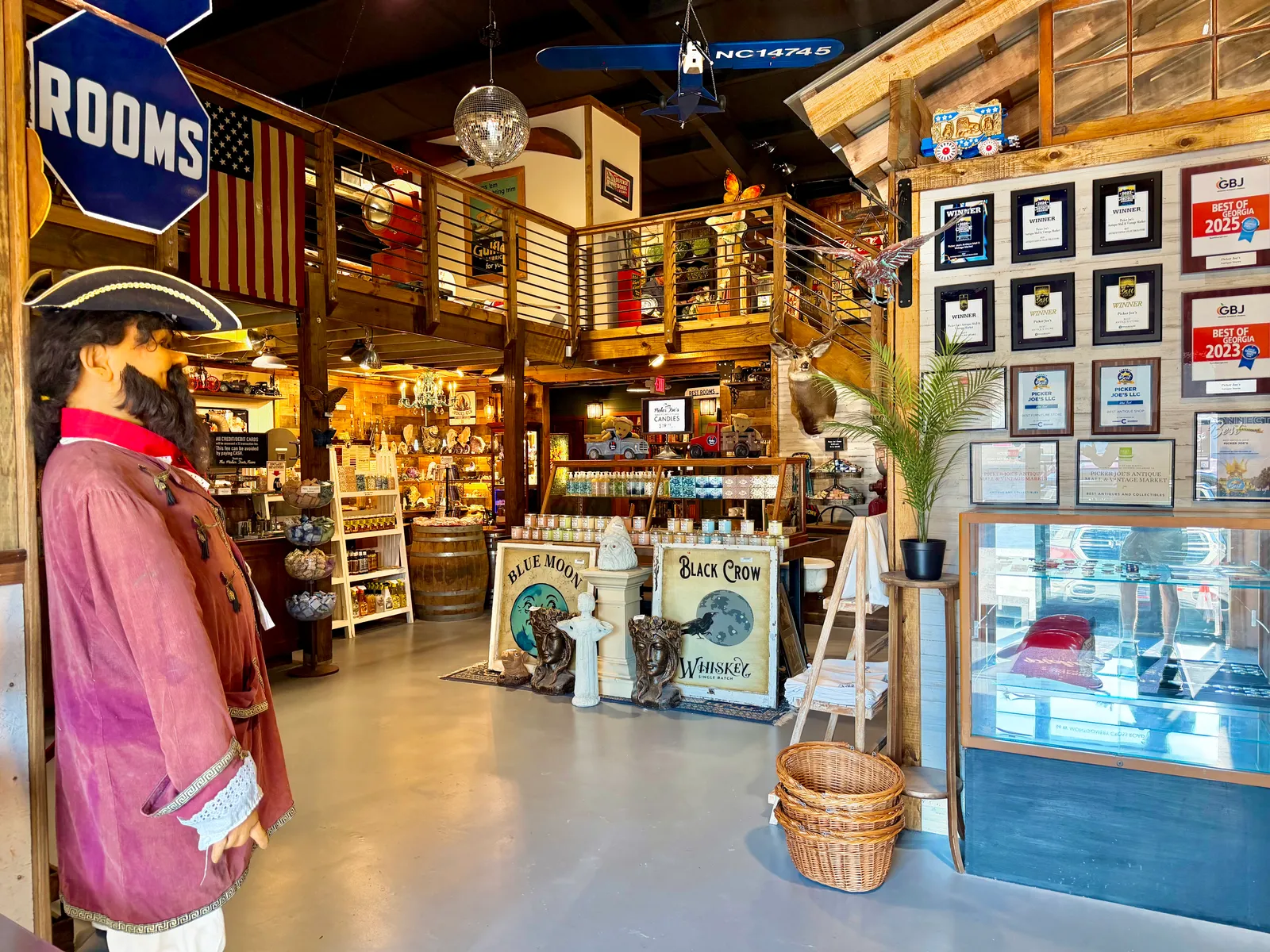 The entrance area with a pirate figure and the awards wall