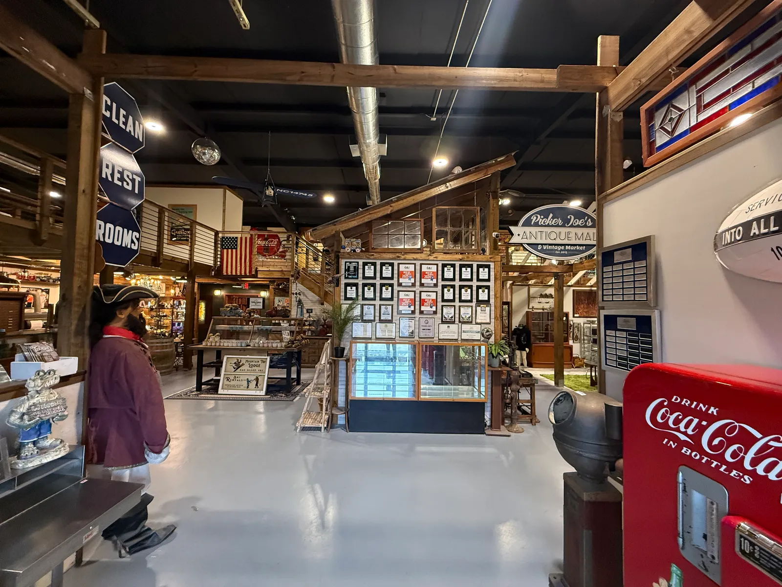An aisle with a vintage Coca-Cola machine